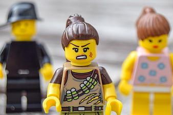 Close-up of Angry LEGO Minifigure with Two Blurred Figures