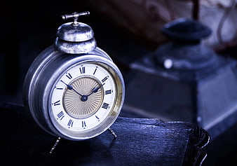Vintage Silver Alarm Clock on Dark Wood