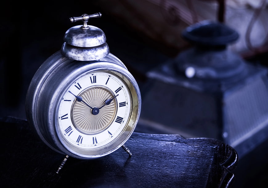 Vintage Silver Alarm Clock on Dark Wood