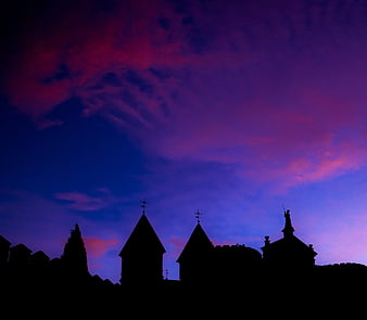 Silhouetted Windmills Against Vibrant Purple and Blue Sunset Sky