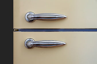 Close-up of vintage cream refrigerator chrome handles
