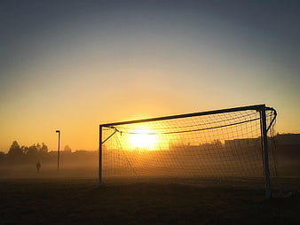 Soccer Goal Silhouette at Misty Sunrise