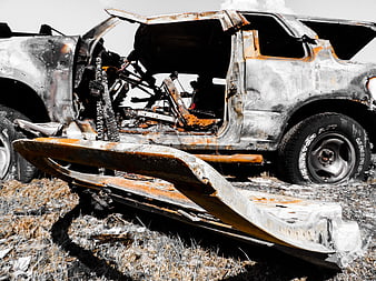 Burnt SUV Wreckage with Rusty Metal and Charred Interior
