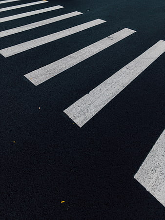 Diagonal View of White Zebra Crossing on Dark Asphalt Road