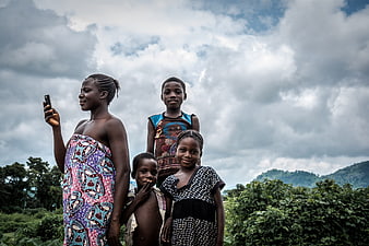African Family Portrait with Smartphone in Rural Landscape