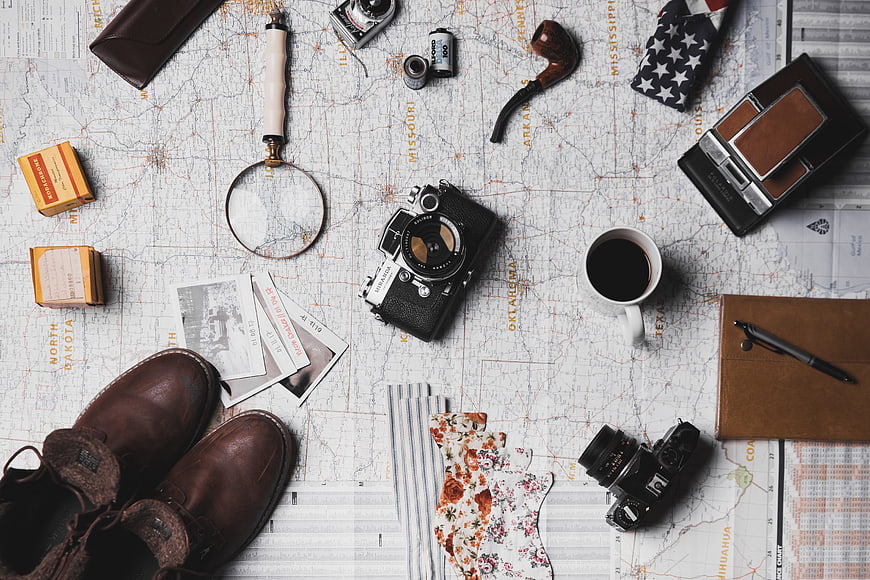 Vintage Travel Flat Lay With Camera, Map, Coffee, and Leather Boots