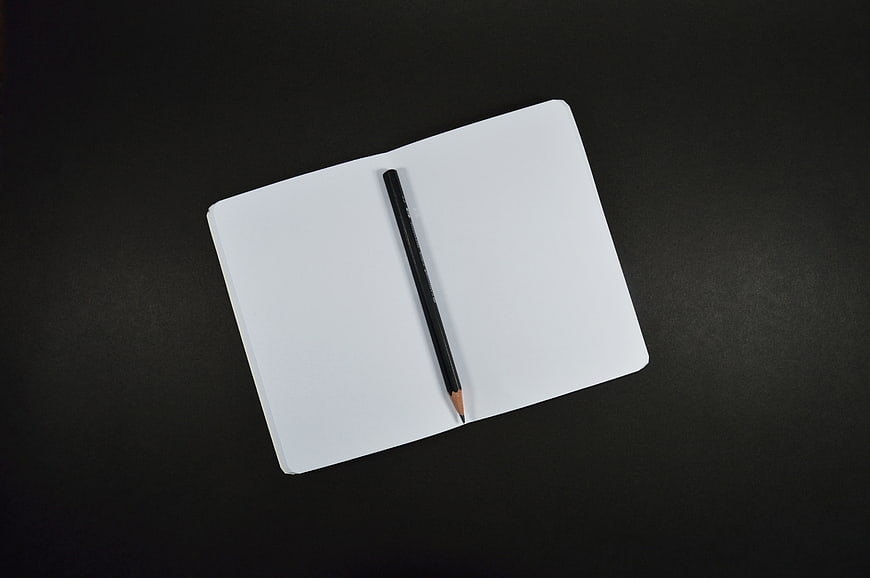 Minimalist White Notebook and Pencil on Black Background