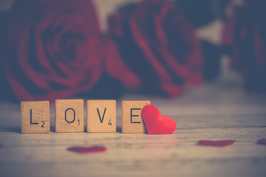 Wooden Scrabble Tiles Spelling Love with Red Heart and Roses