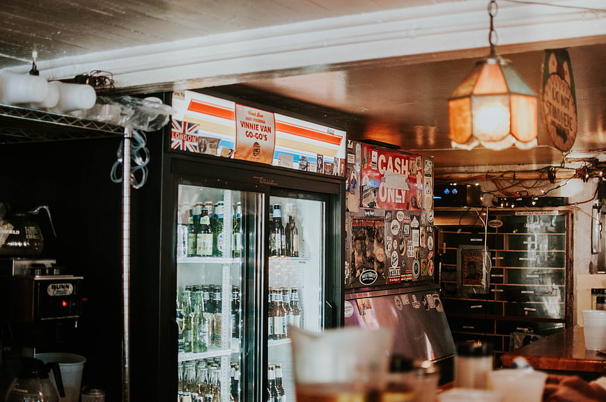 Interior of a cozy cafe with fridge and vintage decor