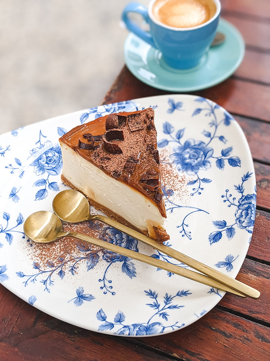 Chocolate Cheesecake Slice with Coffee on Floral Plate