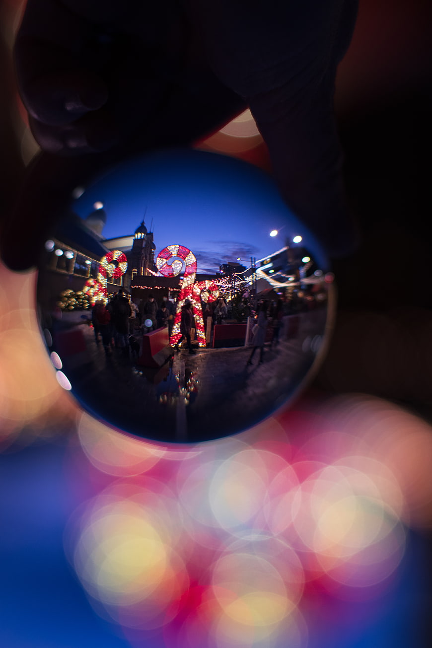 Christmas Market Reflection in Crystal Ball with Bokeh Lights