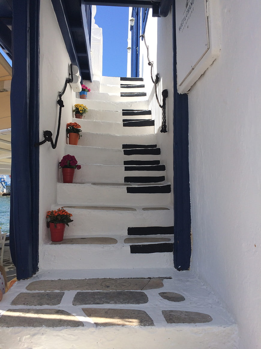 White Staircase with Blue Accents and Flowers in Greece