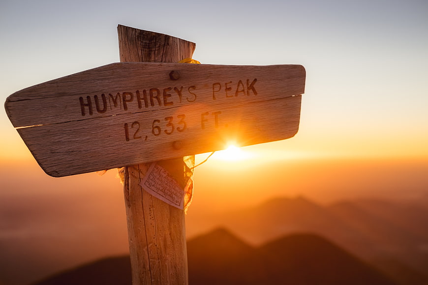 Humphreys Peak wooden sign at sunset with mountain view
