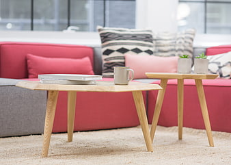Modern wooden coffee tables in a cozy living room with sofa