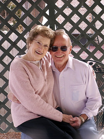 Happy Senior Couple Smiling on Patio Bench