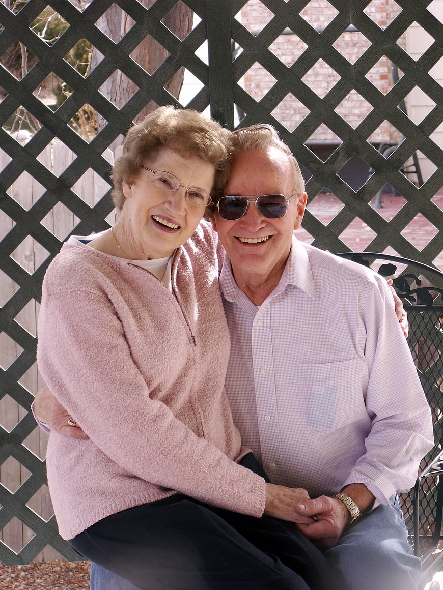 Happy Senior Couple Smiling on Patio Bench