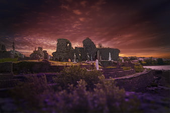 Dramatic Sunset Over Ancient Irish Ruins and Graveyard