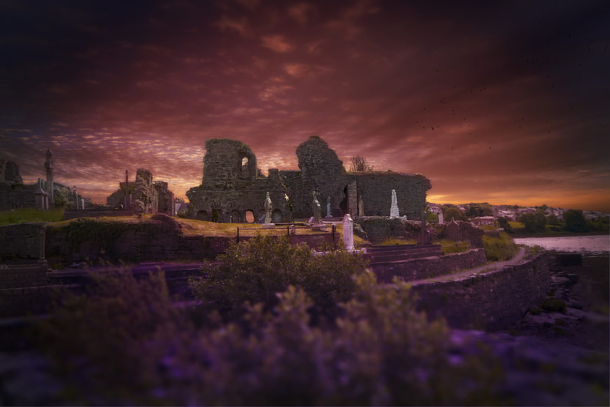 Dramatic Sunset Over Ancient Irish Ruins and Graveyard
