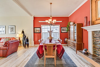 Warm Dining Room With Red Walls And Leather Sofa
