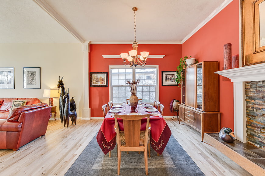 Warm Dining Room With Red Walls And Leather Sofa