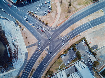 Aerial View of Coastal Road Intersection with Cars and Parking