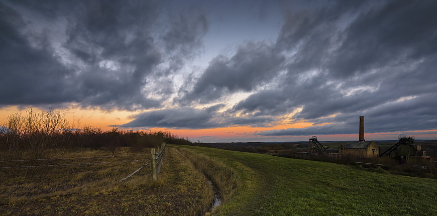 Dramatic sunset over abandoned coal mine landscape