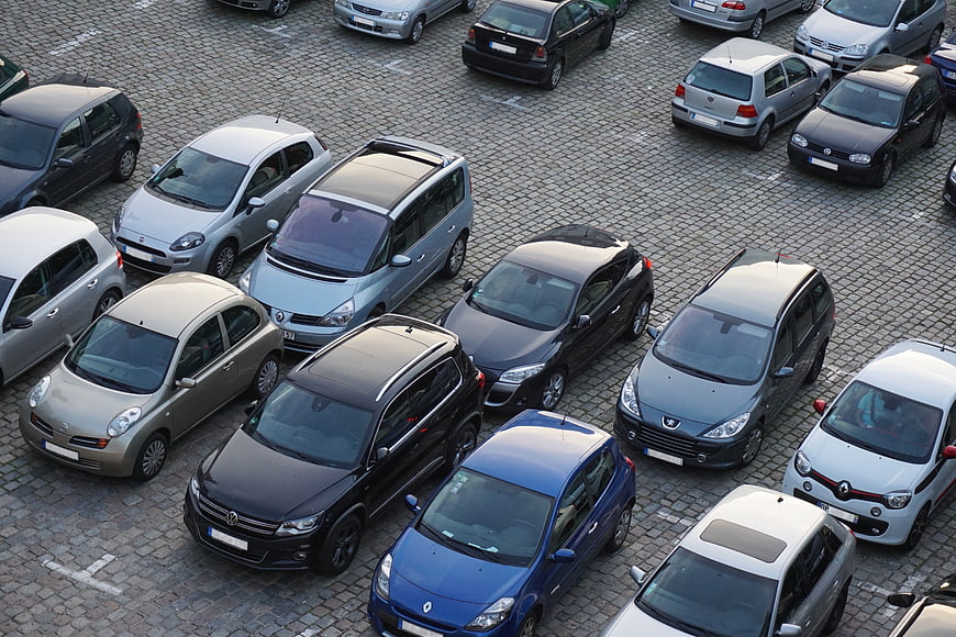 Aerial View of Parked Cars in Urban Cobblestone Parking Lot