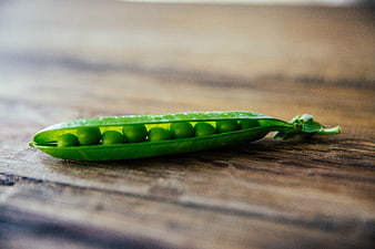 Fresh Green Peas in Pod on Rustic Wooden Table