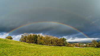 Double Rainbow Over Green Rolling Hills and Forest