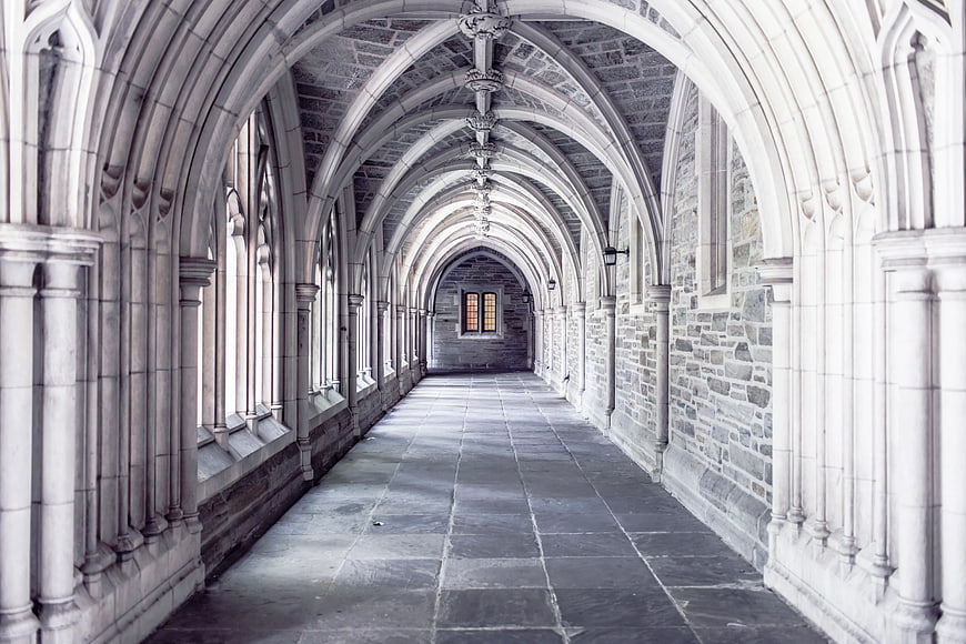 Gothic stone cloister hallway with vaulted arches