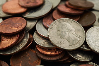 Close-up of mixed US coins including pennies, dimes, and quarters