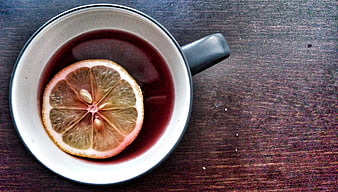 Top view of hot tea with lemon slice in ceramic mug