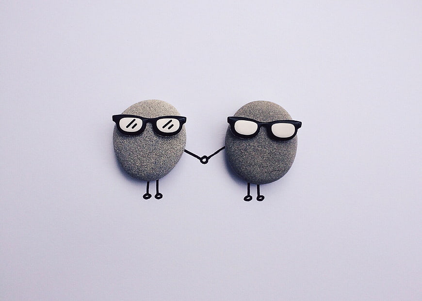 Cute Stone Characters with Glasses Holding Hands