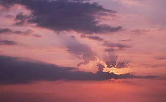 Dramatic sunset sky with purple clouds and sun rays