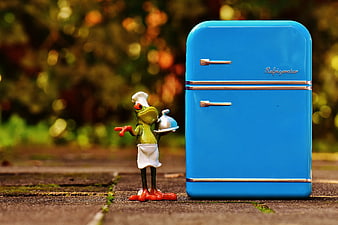 Cute Frog Chef Figurine Standing Next To Blue Miniature Refrigerator