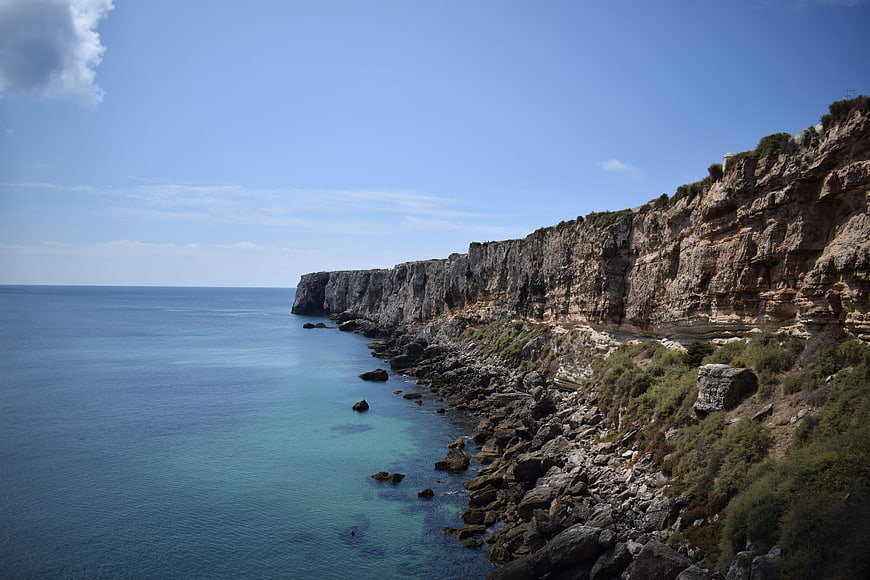Dramatic coastal cliffs meeting turquoise Atlantic waters in Portugal