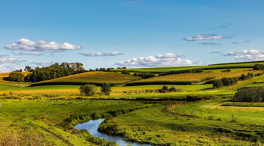 Scenic Wisconsin farmland landscape with winding stream and rolling hills
