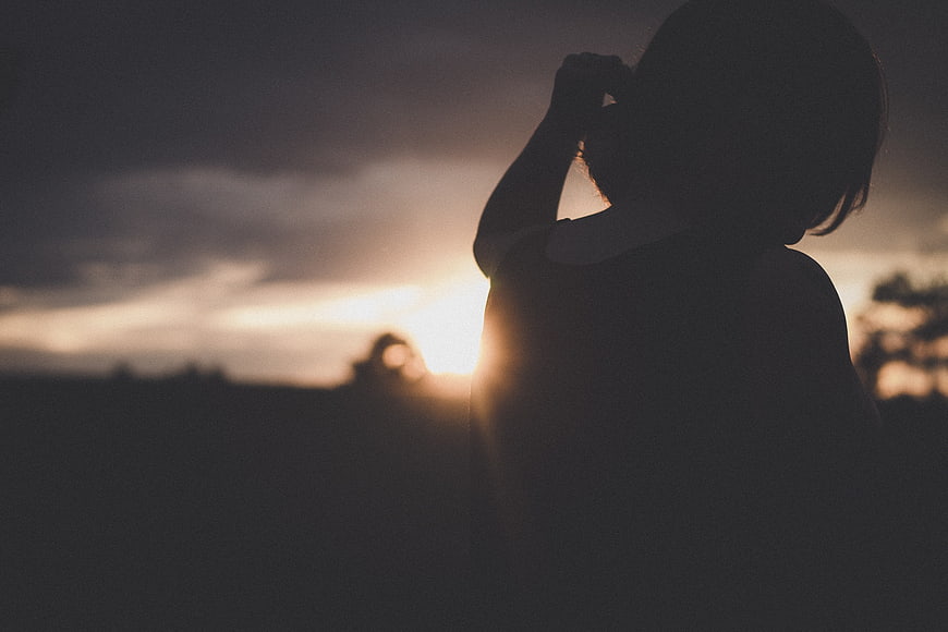 Silhouette of Woman Looking at Sunset Sky
