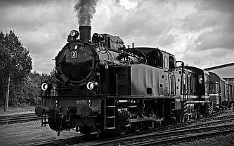 Vintage Steam Locomotive on Railroad Tracks