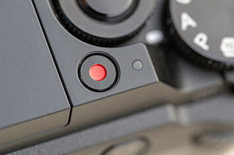 Close-up of camera red record button and mode dial