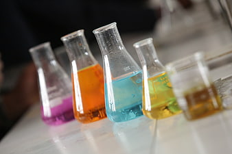 Colorful Chemical Solutions In Glass Erlenmeyer Flasks