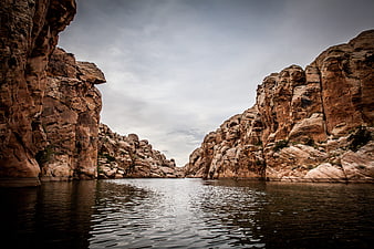 Dramatic Canyon River Landscape With Rocky Cliffs And Calm Water