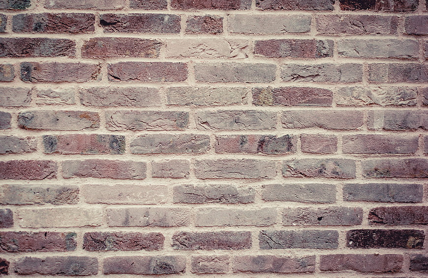 Textured Old Brick Wall Background with Weathered Stones