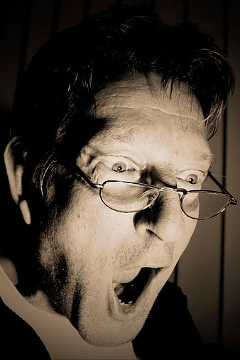 Close-up of terrified man screaming in sepia tone