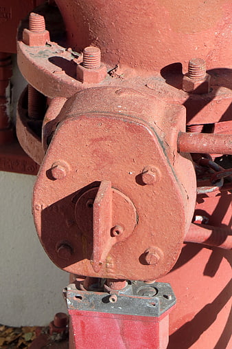 Close-up of red industrial fire hydrant valve mechanism