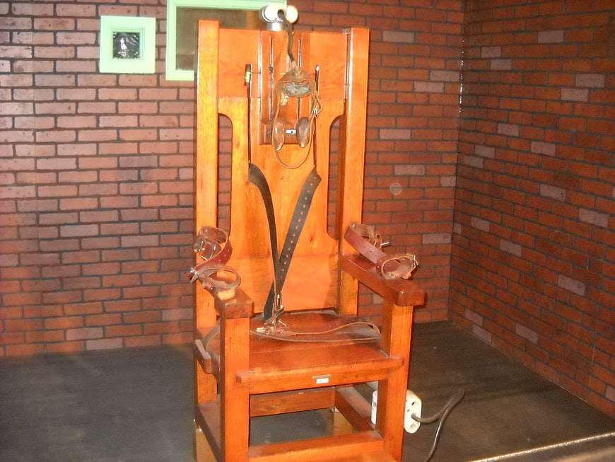 Historic Electric Chair in Brick Room Museum Exhibit