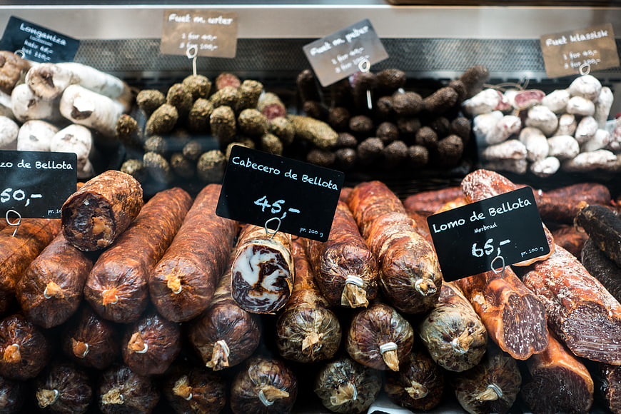 Assorted Spanish cured sausages and salami in a deli display