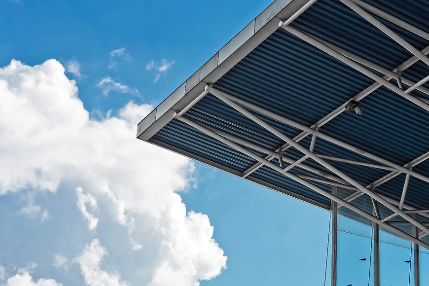 Modern Metal Roof Structure Against Blue Sky