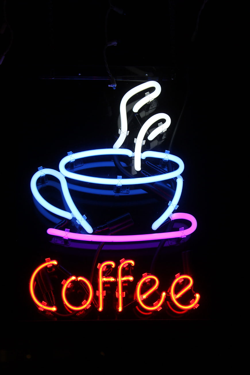 Neon Coffee Cup Sign with Glowing Text on Black Background