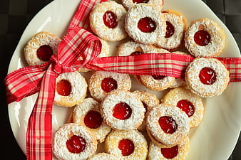 Christmas Linzer Cookies With Red Ribbon On White Plate